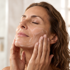 Woman applying Second Spring Facial Cleanser to her face