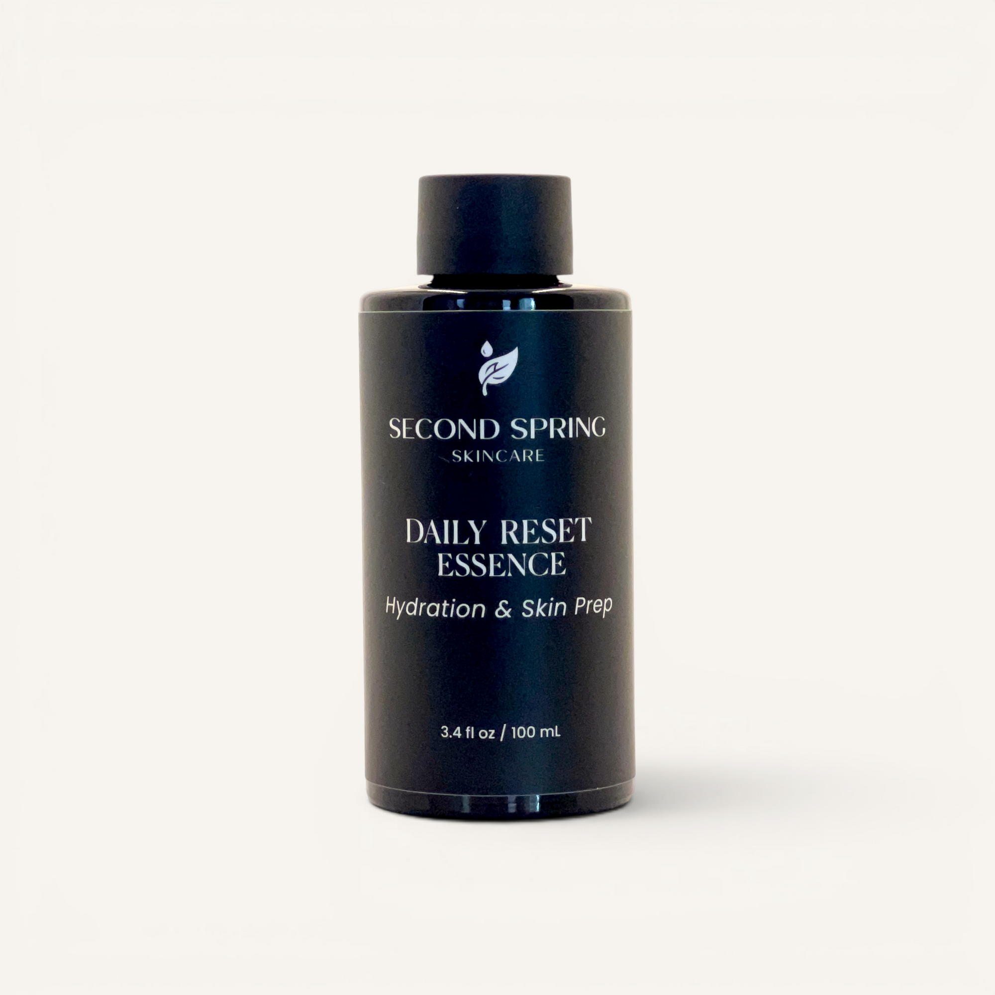 Black bottle of Second Spring Skincare Daily Reset Essence on a white background
