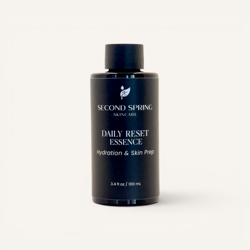 Black bottle of Second Spring Skincare Daily Reset Essence on a white background