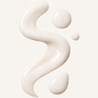 White cream or lotion in a flowing pattern on a light background