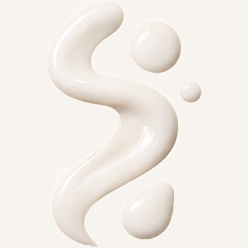 White cream or lotion in a flowing pattern on a light background